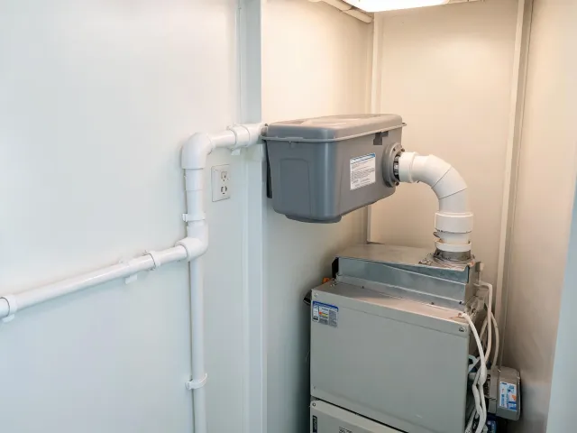 Compact condensate pump in HVAC closet